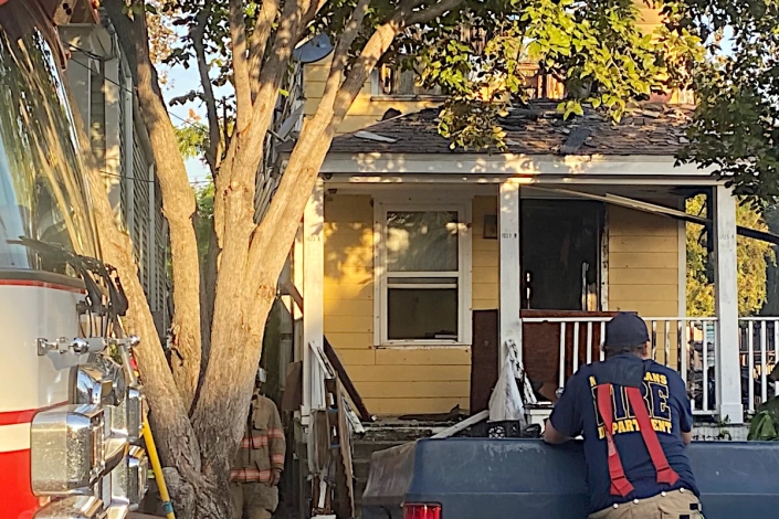 House Damaged by Fire in the Bywater. Emergency Crews on the Scene.