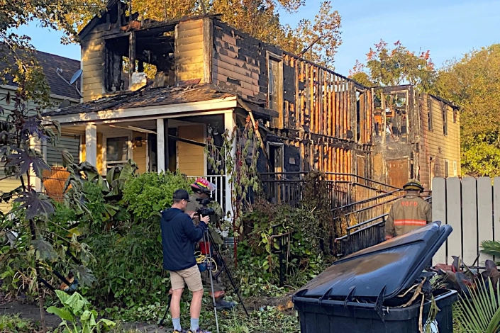 House Damaged by Fire in the Bywater. Emergency Crews on the Scene.