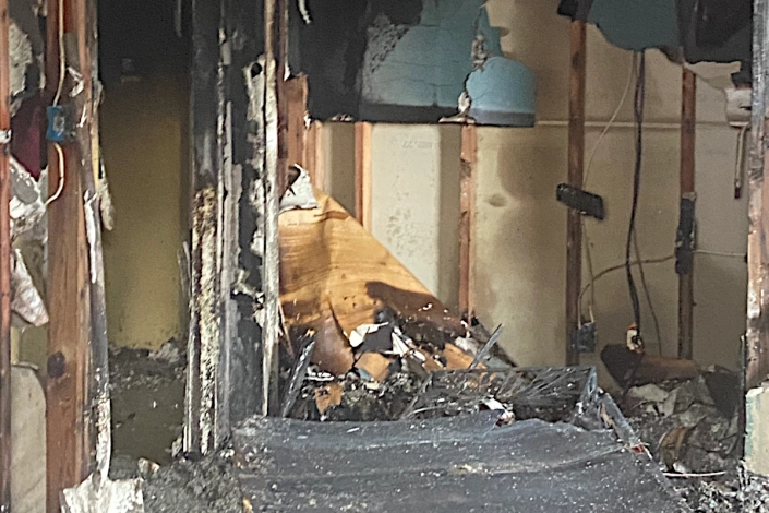 House Damaged by Fire in the Bywater. Emergency Crews on the Scene.