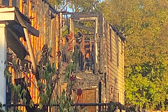 House Damaged by Fire in the Bywater. Emergency Crews on the Scene.